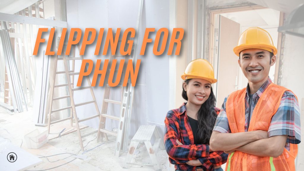 Two people in construction clothes arms folded, man and woman, in frontn of construction house.